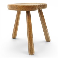 Squirrelman - rustic oak milking stool, adzed shaped top with exposed peg construction, on three tapering supports, with large carved squirrel signature, by Wilf Hutchinson, Husthwaite