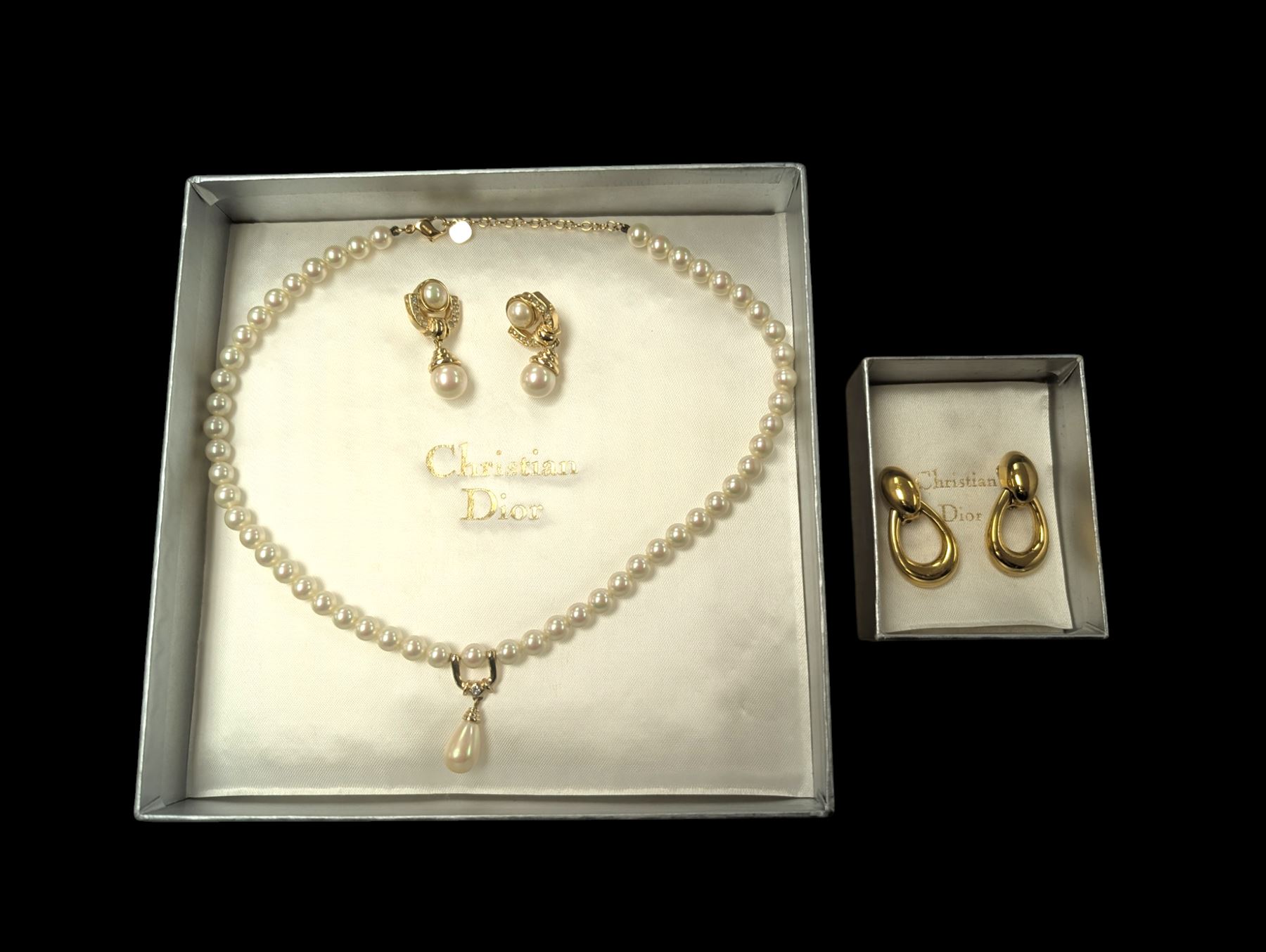 Pair of Christian Dior clip on hoop earrings, stamped Chr.Dior, together with a faux pearl necklace and similar clip on earrings, stamped Grosse, both within Christian Dior boxes