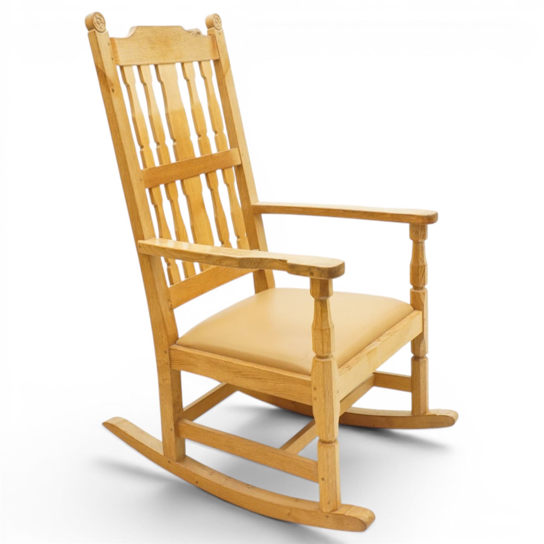 Beaverman - oak 'Ripley' rocking chair with shaped lathe backs and leather seat, with signature Beaver carving to the top rail, flanked by Yorkshire Roses, by Colin Almack of Sutton near Thirsk