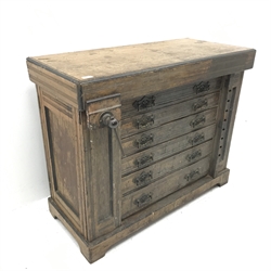 Late 19th century work bench tool cabinet, hinged lid enclosing tool rack, single vice, six graduating drawers, storage cupboards at both ends, inlaid Melhusih plaques,  shaped plinth base by Richard Melhuish & Sons, London(W107cm, H88cm, D50cm) and a quantity of hand tools