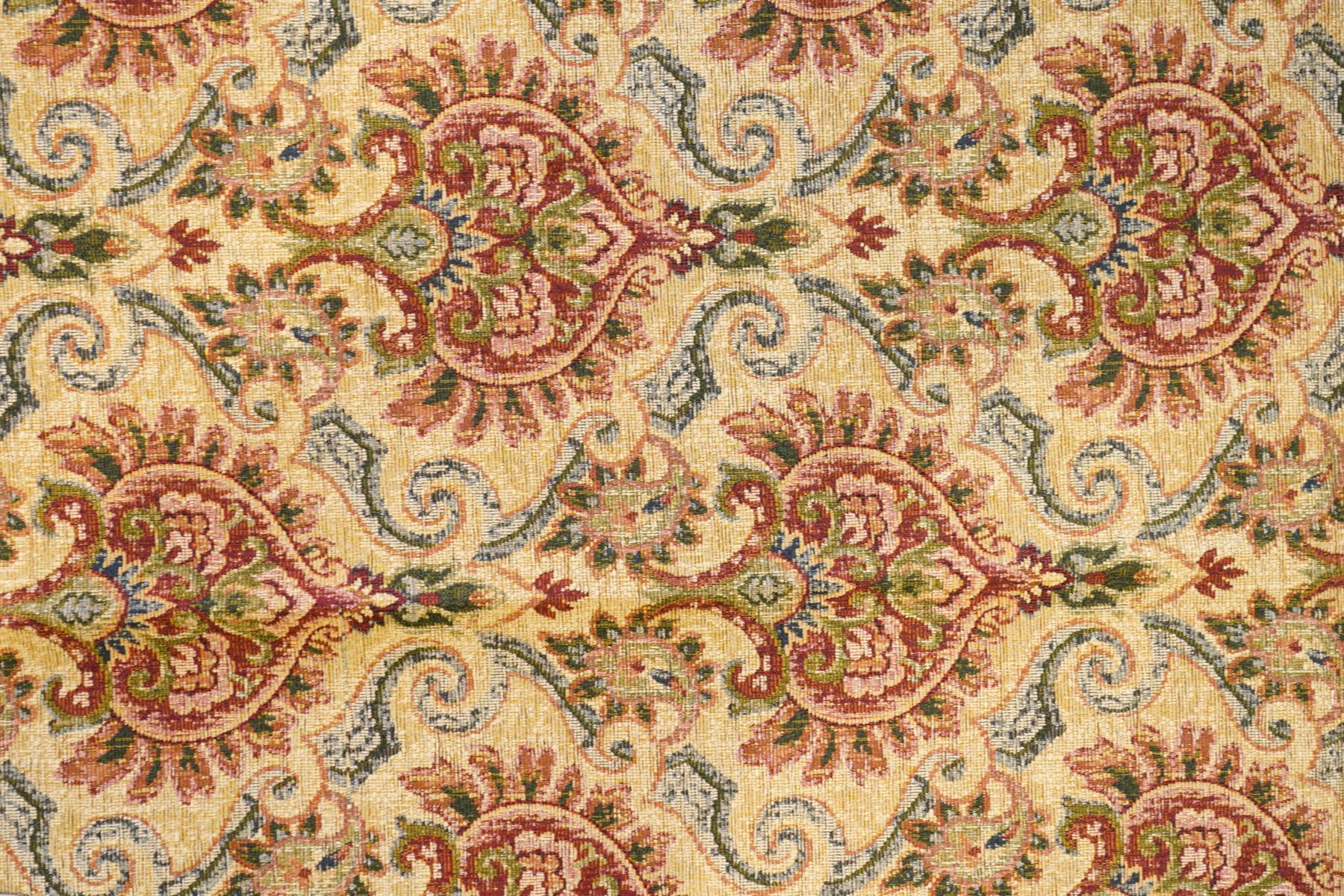 Pale golden ground chenille fabric section, decorated with repeat stylised plant motifs and trailing scrolls