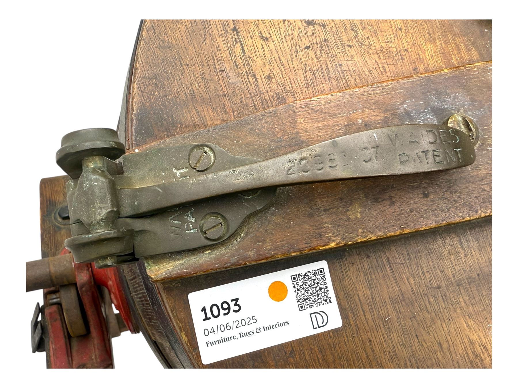 19th century oak and cast iron rotary butter churn, with coopered barrel body, domed lid with filler opening and cast iron securing arms, on tilting iron-mounted frame with crank handle and support rails