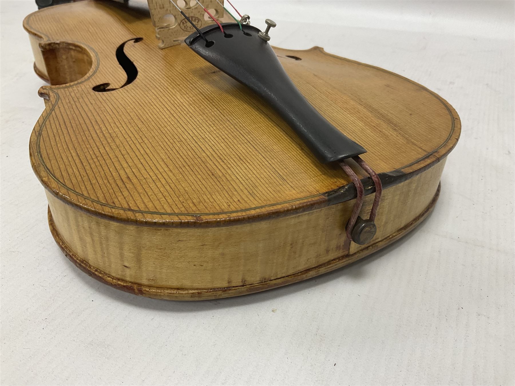 Copy of a full size Stradivarius violin, with an ebonised fingerboard, tailpiece and tuning pegs Length 60cm