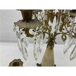 French brass and marble four branch candelabra, the branches cast with ornate foliate scrolls with leafy nozzles and drip pans hung with prismatic drops raised upon tapering central marble column, together with two candlesticks, tallest H42cm