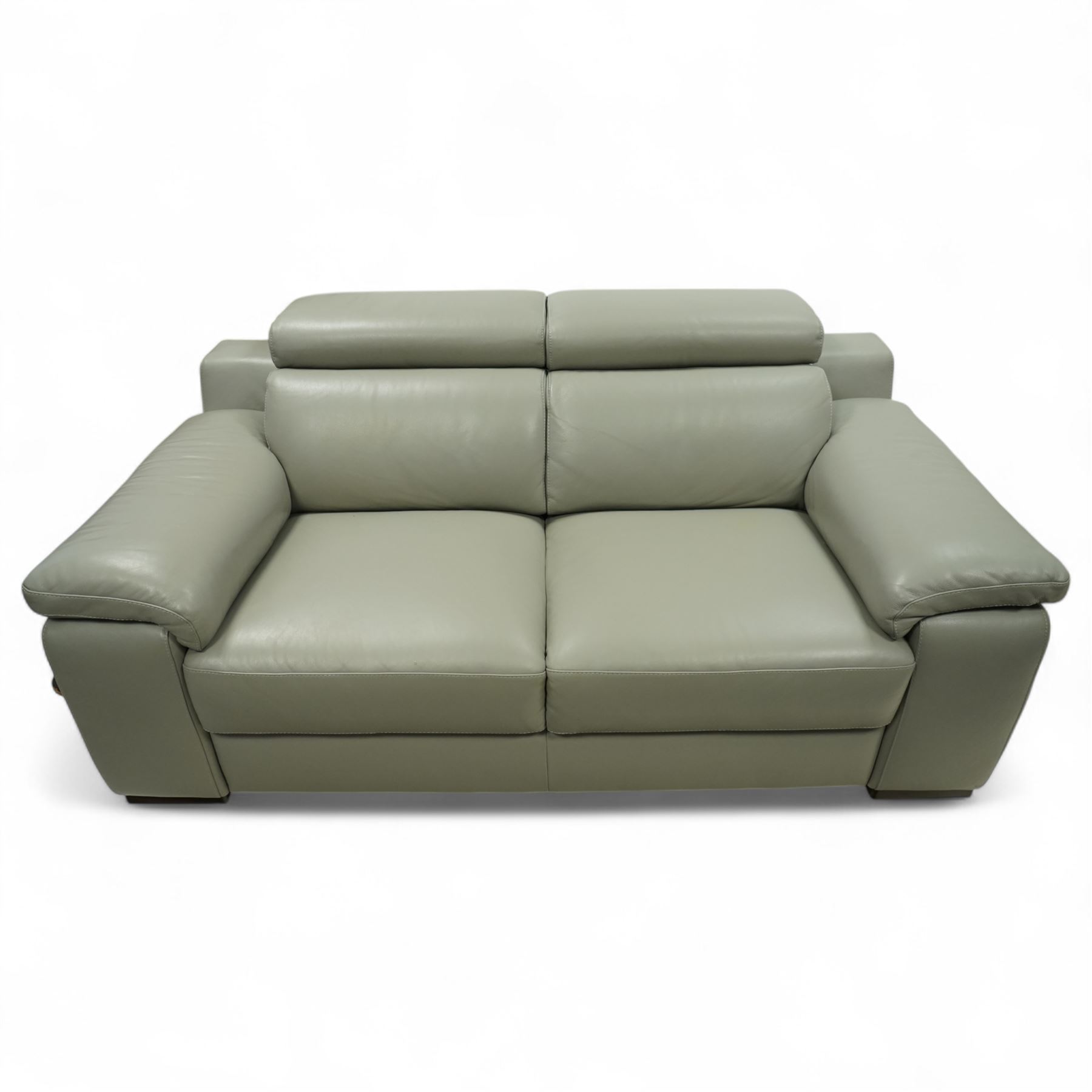 Modern Italian style leather two-seat sofa, upholstered in pale grey leather with panel stitched cushioning, with retractable head rests and broad arms, raised on square feet