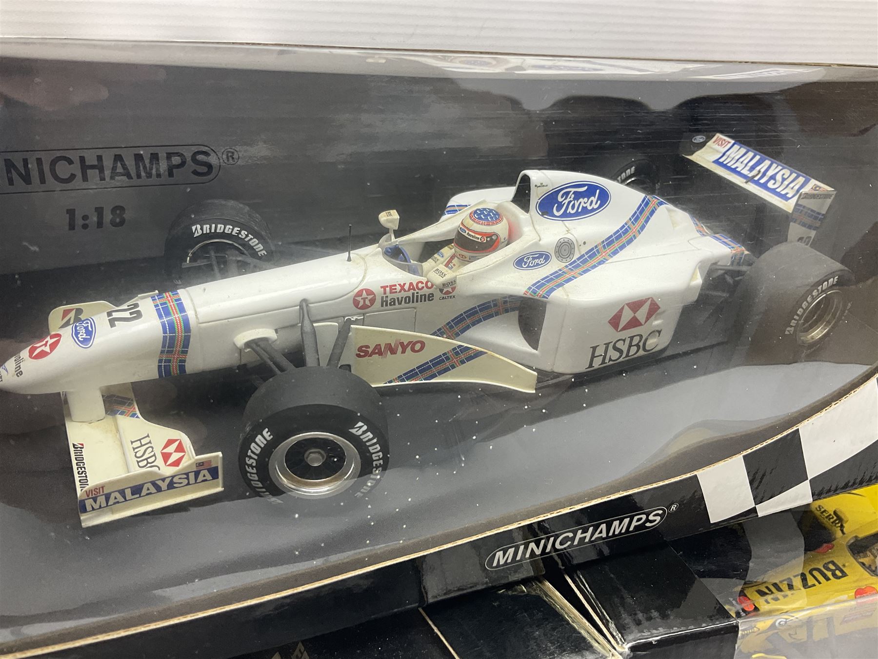Three Minichamps 1:18 scale die-cast racing cars - Jordan Mugen Honda 198 D. Hill; Jordan Ford EJ13 G. Fisichella; and Stewart Ford SF 1 R. Barrichello; all boxed (3)
