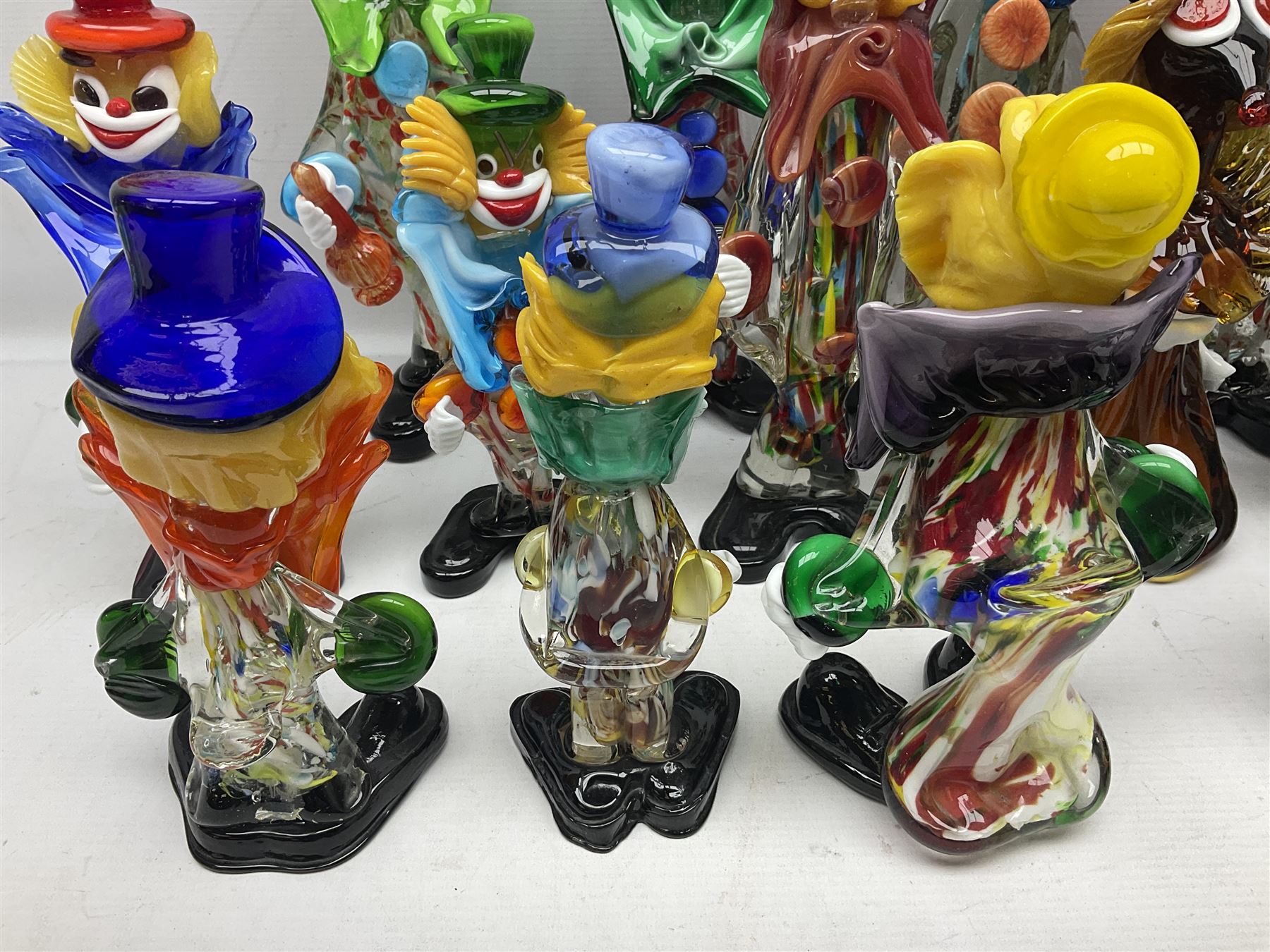 Large quantity of Murano glass clowns, to include larger examples, in two boxes