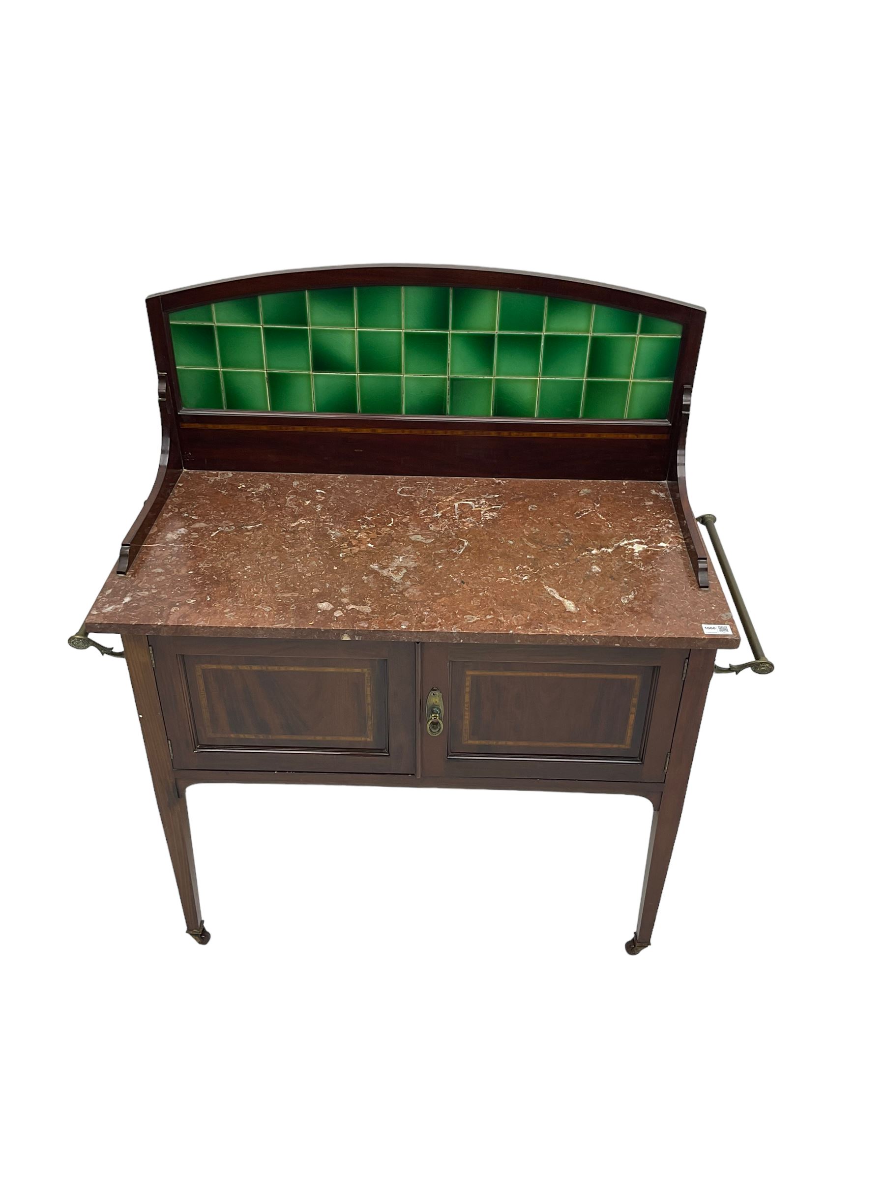 Edwardian inlaid mahogany washstand, raised back with emerald green tiles over marble top, fitted with two panelled cupboard doors, raised on square tapering supports on ceramic castors