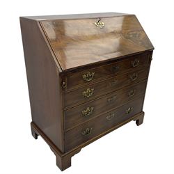 George III mahogany bureau, fall-front enclosing a fitted interior of drawers, pigeonholes and central mirrored cupboard, over four graduated cockbeaded drawers with brass batwing handles, raised on bracket feet