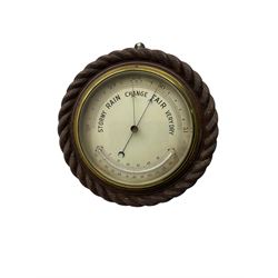 Edwardian - 8-day ships bulkhead clock and an Aneroid barometer.
In matching circular oak cases with carved rope twist bezels.
Clock with a painted metal dial, Roman numerals, minute track and steel spade hands, small seconds hand and platform regulation. Case 9