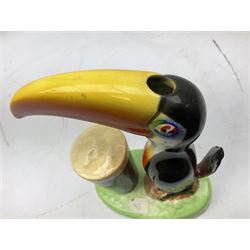 Carltonware Guinness advertising table lamp (lacking fitting) in the form of a toucan with a glass of Guinness, the base depicting 'How grand to be a toucan Just think what Toucan can do If he can say as you can Guinness is good for you', with black printed marks to the base (tail a/f)