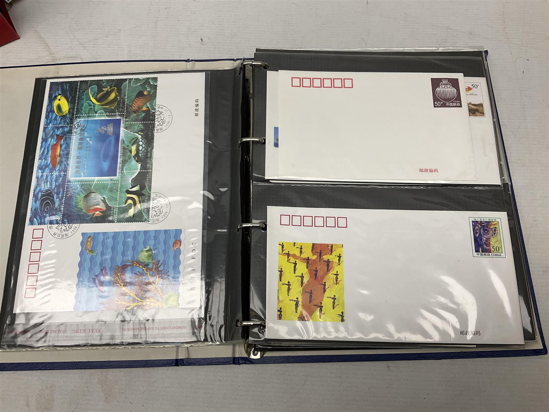 Mostly Chinese stamps including  covers and postcards, many being from the 80s and 90s, housed in ten folders