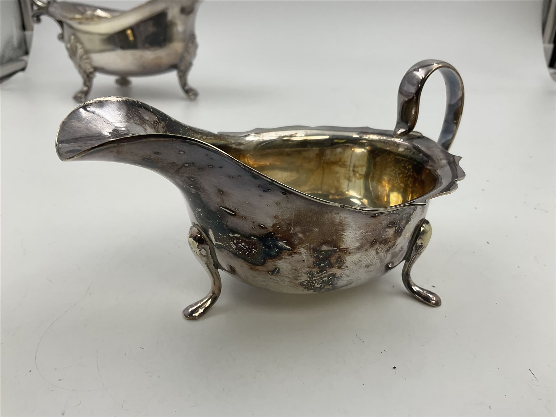 Silver plated seven bar toast rack by Mappin & Webb, together with other silver plated items including pair of bottle coasters, swing handled baskets and two sauce boats