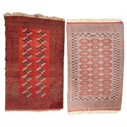 Afghan Turkoman crimson ground rug decorated with twin rows of hooked geometric guls withi...