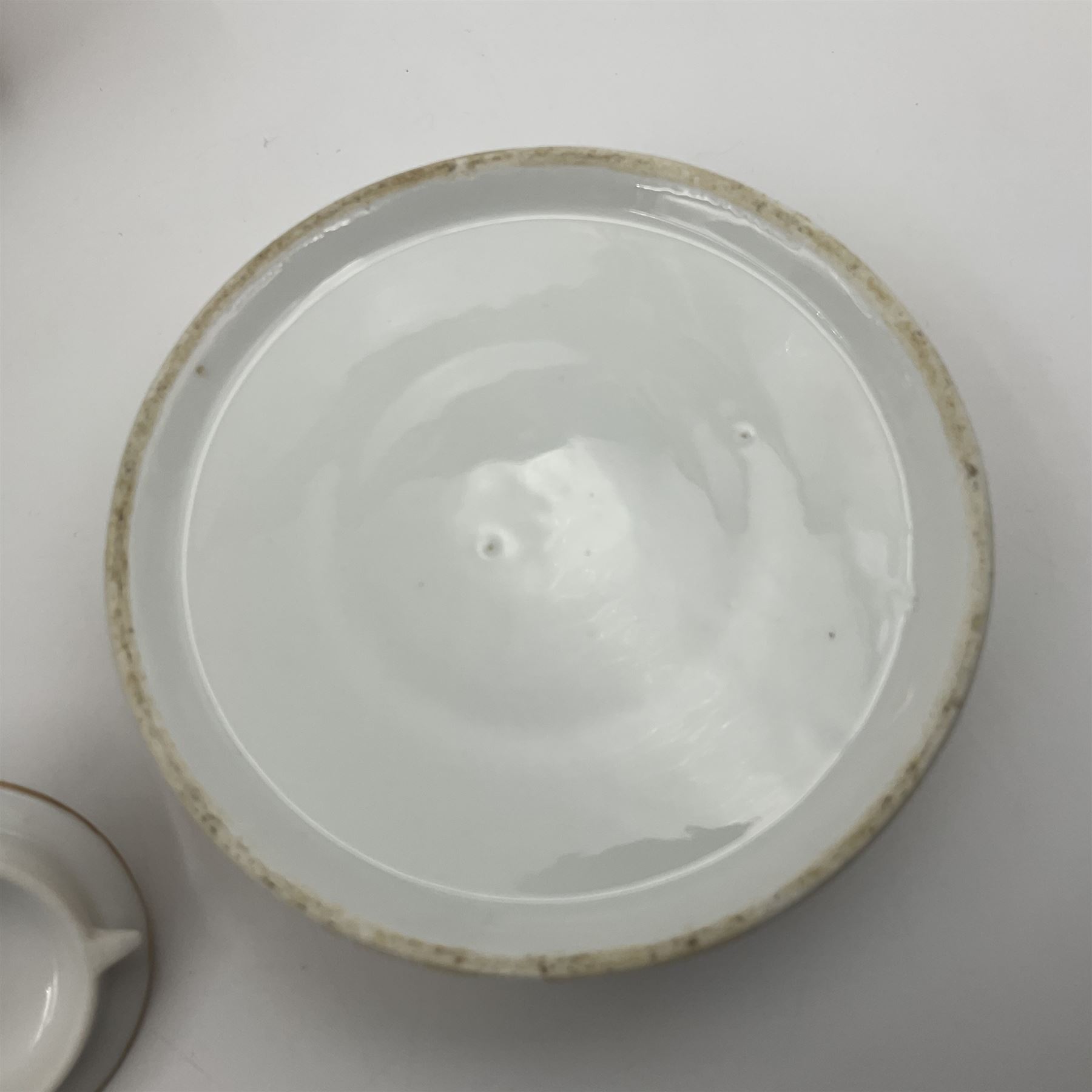 Two 19th century continental teapots and warmers, each teapot upon a cylindrical warming base in the form of a castle, hand printed with winter landscapes, largest H22cm 