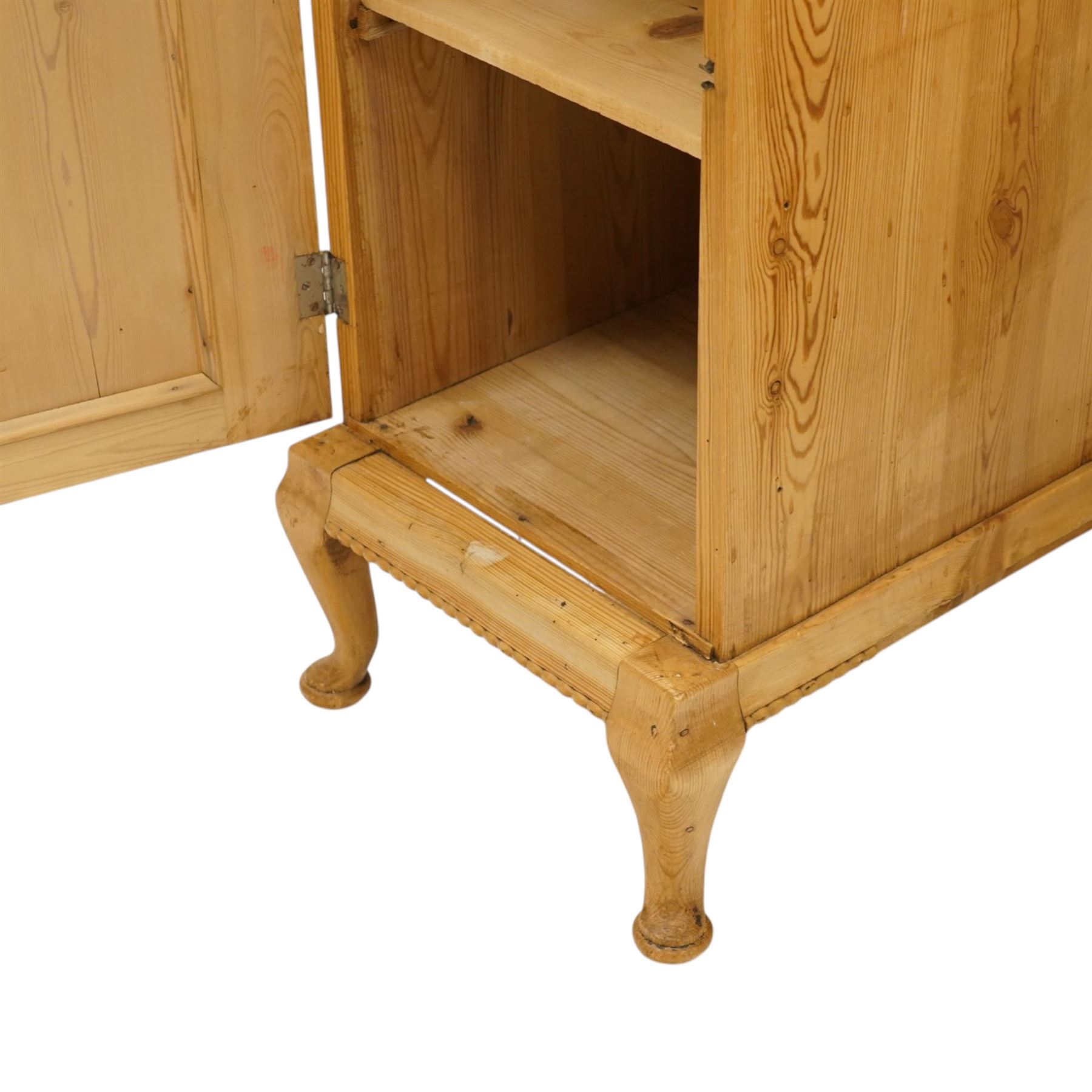Pair of early 20th century pitch pine bedside cabinets, door with applied foliate carving, raised on cabriole legs