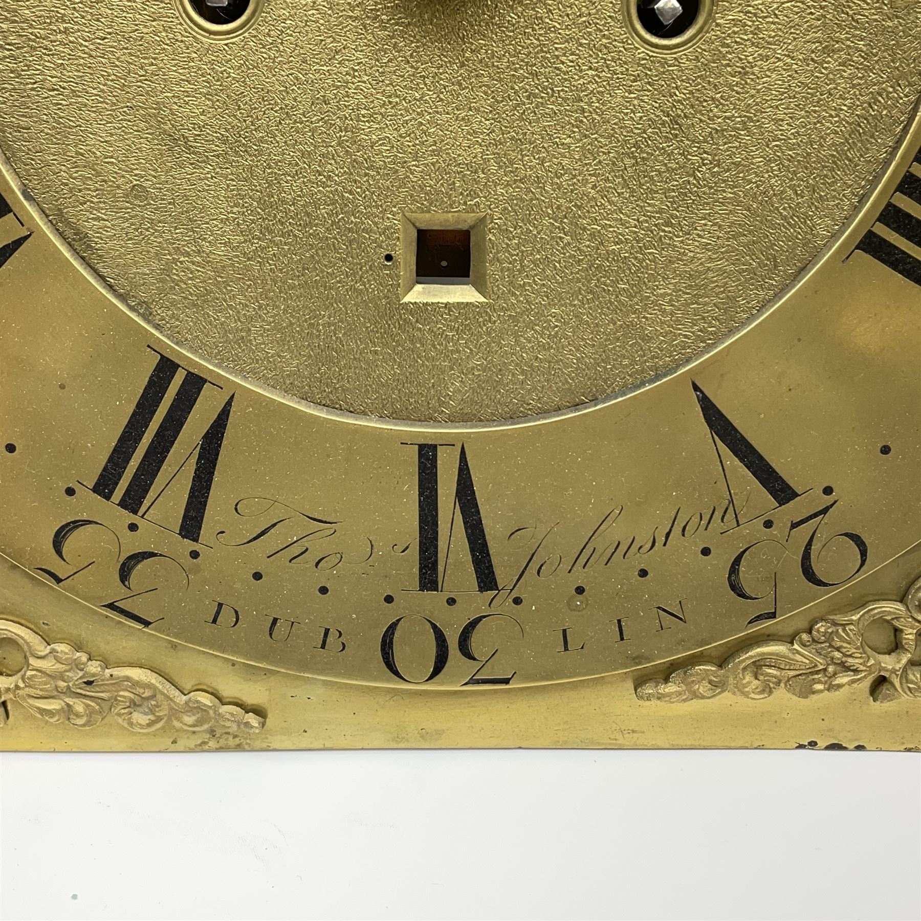 Late 18th century clock movement and dial, square brass dial with Arabic and Roman chapter ring signed 'Thos. (Thomas) Johnston, Dublin', with subsidiary seconds dial and calendar aperture, the dial set with ornate mask cast spandrels, twin train eight day movement striking on bell, with anchor escapement (34.5cm x 34.5cm, 13 1/2