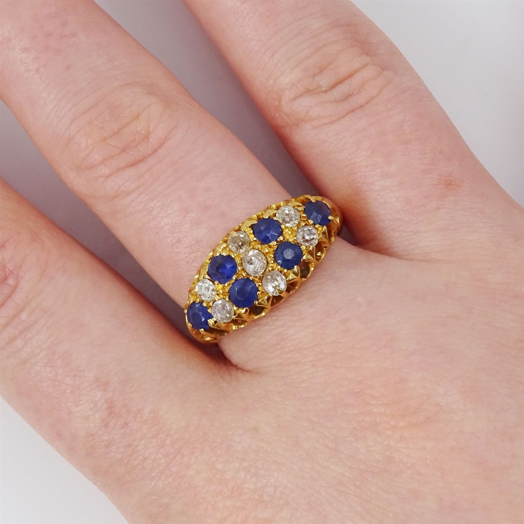 19th / early 20th century 18ct gold diamond and sapphire ring, three rows of old cut diamonds, each spaced by round cut sapphires, total diamond weight approx 0.50 carat