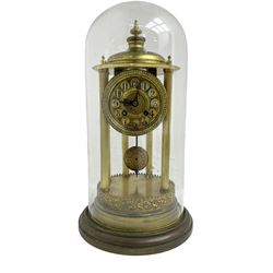 French - early 20th century 8-day portico clock under a glass dome, on a shaped circular brass base with a decorative repousse border to the plinth, six reeded columns with finials and an ogee top with matching finial, gilt dial with cartouche Arabic numerals and pierced hands, countwheel striking movement, striking the hours and half hours on a bell. With pendulum and key. 