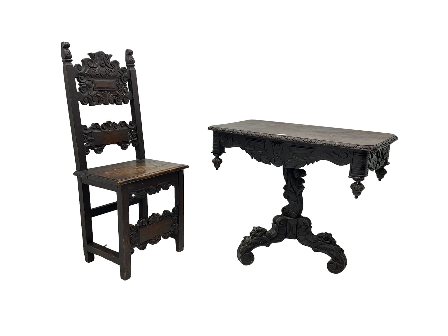 Late 19th century Gothic revival carved oak pedestal table, rectangular top with carved edges, apron carved with trailing foliate and scrolled decoration, heavily detailed column with scrolling decoration and floral carvings, the tripod base with cabriole supports carved with flowerheads (93cm x 53cm x 75cm; Late 19th century carved oak hall chair, panelled back rails with extending scroll decoration (51cm x 40cm x 116cm)