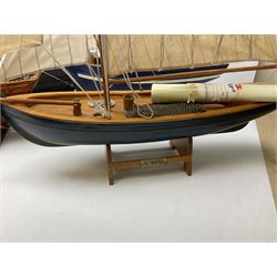 Eight model ships or boats including fishing boat with fish, nets and buoyancy aid, two mast sailing ship complete with cannons, two mast yacht with detailed rigging and life boat etc, the largest L72cm, H60cm