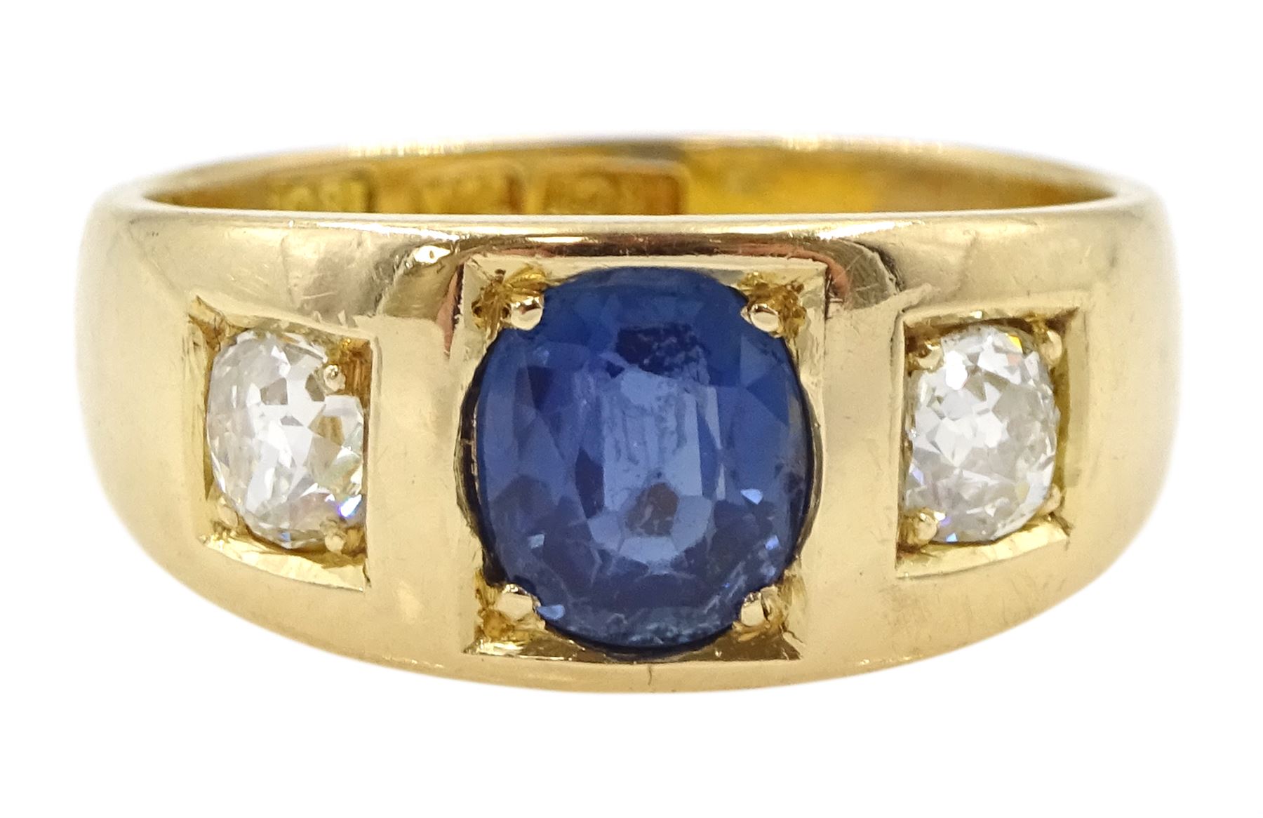 Late 19th century continental gypsy set three stone oval sapphire and old cut diamond ring, stamped 18ct, makers mark HA, total diamond weight approx 0.45 carat, sapphire approx 1.05 carat