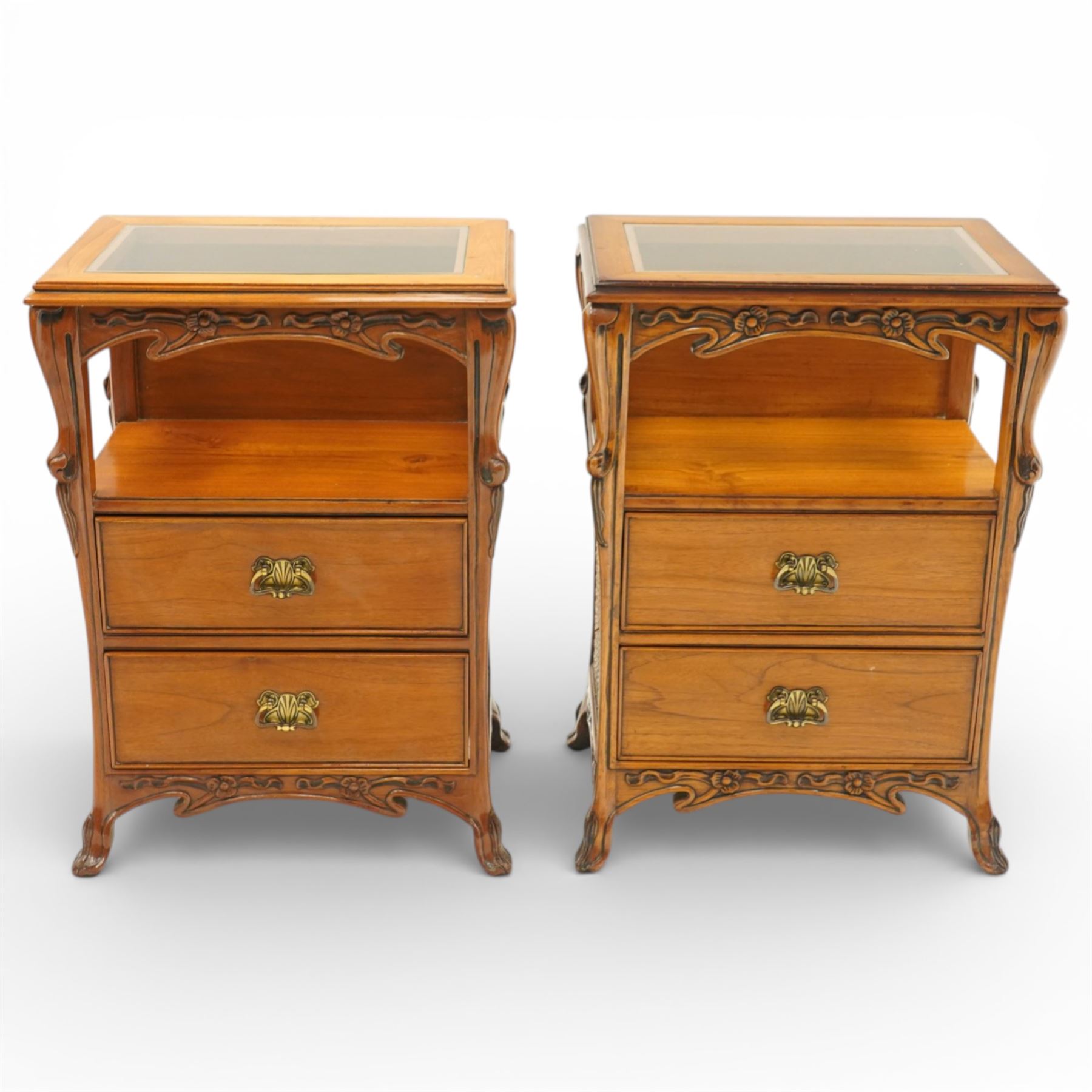 And So To Bed - pair of cherry wood and cane 'Libertine' bedside tables, glass top above a shaped and carved apron, with open recess above two drawers with brass handle, flanked by caned sides, raised on short cabriole supports 