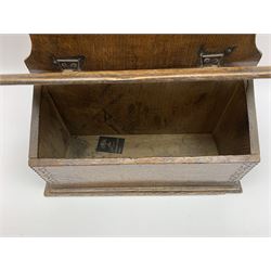 George III oak spoon rack and candle box, the shaped and pierced back with spoon rack, above a candle box enclosed by sloped lid with chip carved edge and geometric patterned carved band, H61cm L39cm D14.5cm