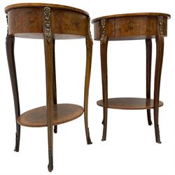 Pair of early 20th century French walnut bedside stands, oval bookmatched and cross-banded top fitted with single drawer, raised on cabriole supports united by undertier, decorated with floral gilt metal mounts