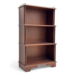 Mid-20th century mahogany open bookshelf, the rectangular top with a brass balustrade gallery, over three shelves each supported by turned column uprights, on shaped apron base