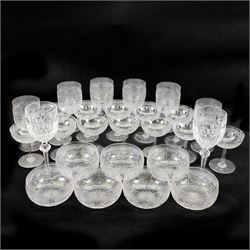 Six cut glass goblets, each with etched and cut floral decoration, together with eight similar bowls, a pair of Waterford Crystal glasses, eight champagne coupes etched with Greek Key border and four etched with floral border