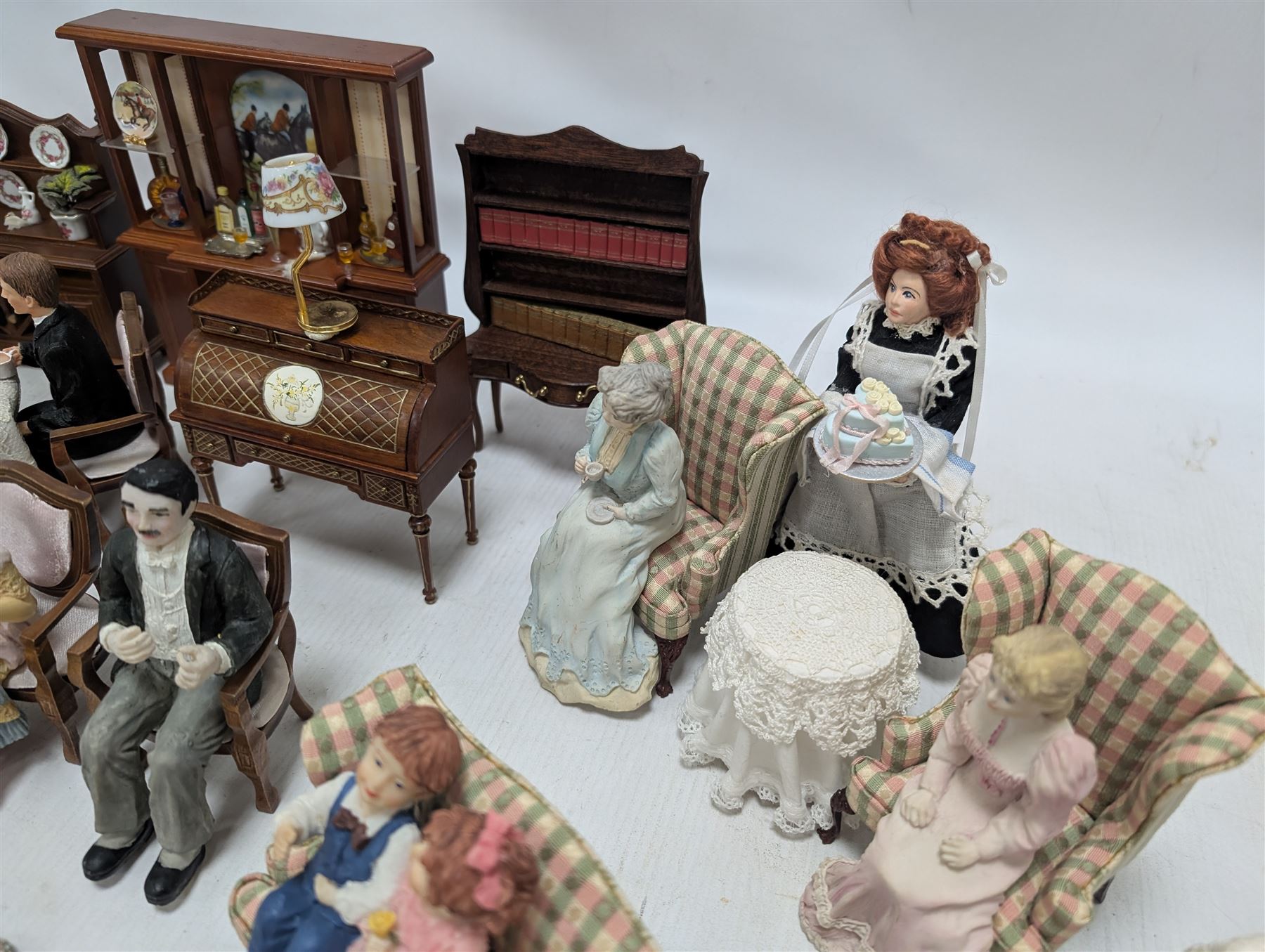Dolls house drawing room furniture, including dressers, pink and green checked sofa and armchairs, bureau, chairs, piano, eight figures and a collection of afternoon tea miniatures
