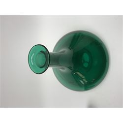 19th century green glass ships decanter with flat topped stopper, H21.5cm, together with a set of four 19th century green glass wine glasses, the funnel bowls upon bladed knopped stems and circular feet, H13cm