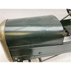 Mid 20th century pressed steel pedal car, the body painted in dark green fitted with pretend radiator to the bonnet, with spoked wheels and rubber tyres, the interior with pedals and steering wheel, L70cm