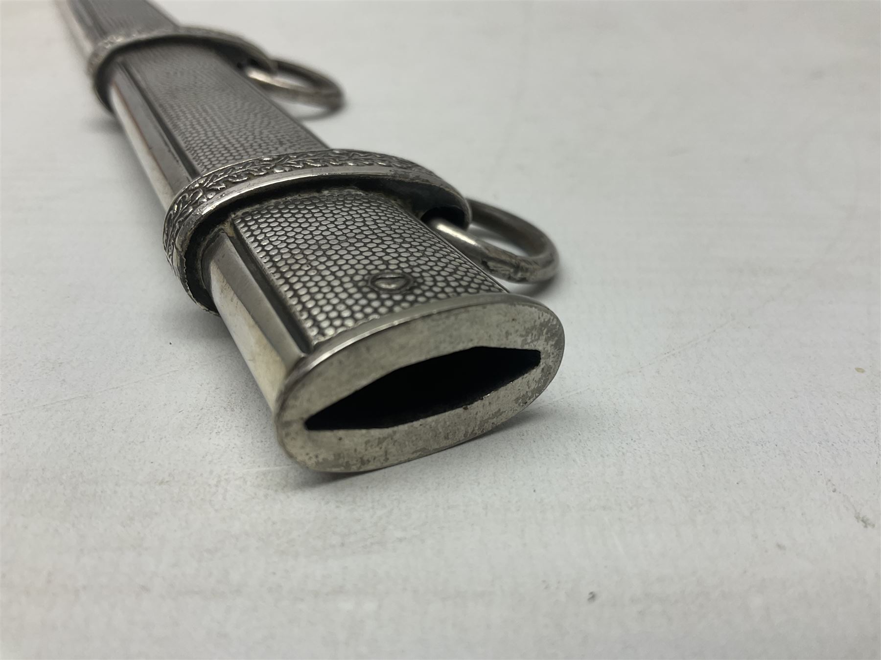 Late WW2 German Army Officers dress dagger, with unmarked 25cm double edged steel blade, orange celluloid grip, pommel and ferrule with oakleaves relief and cross guard with eagle; in original beaded scabbard with two hanging rings L39.5cm overall