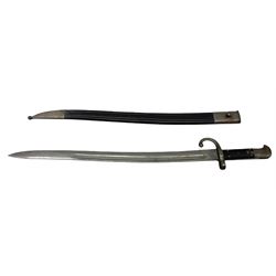 Turkish Model 1874 sword bayonet with 57.5cm curving steel fullered blade and chequered black grip, in steel mounted leather scabbard L75.5cm overall