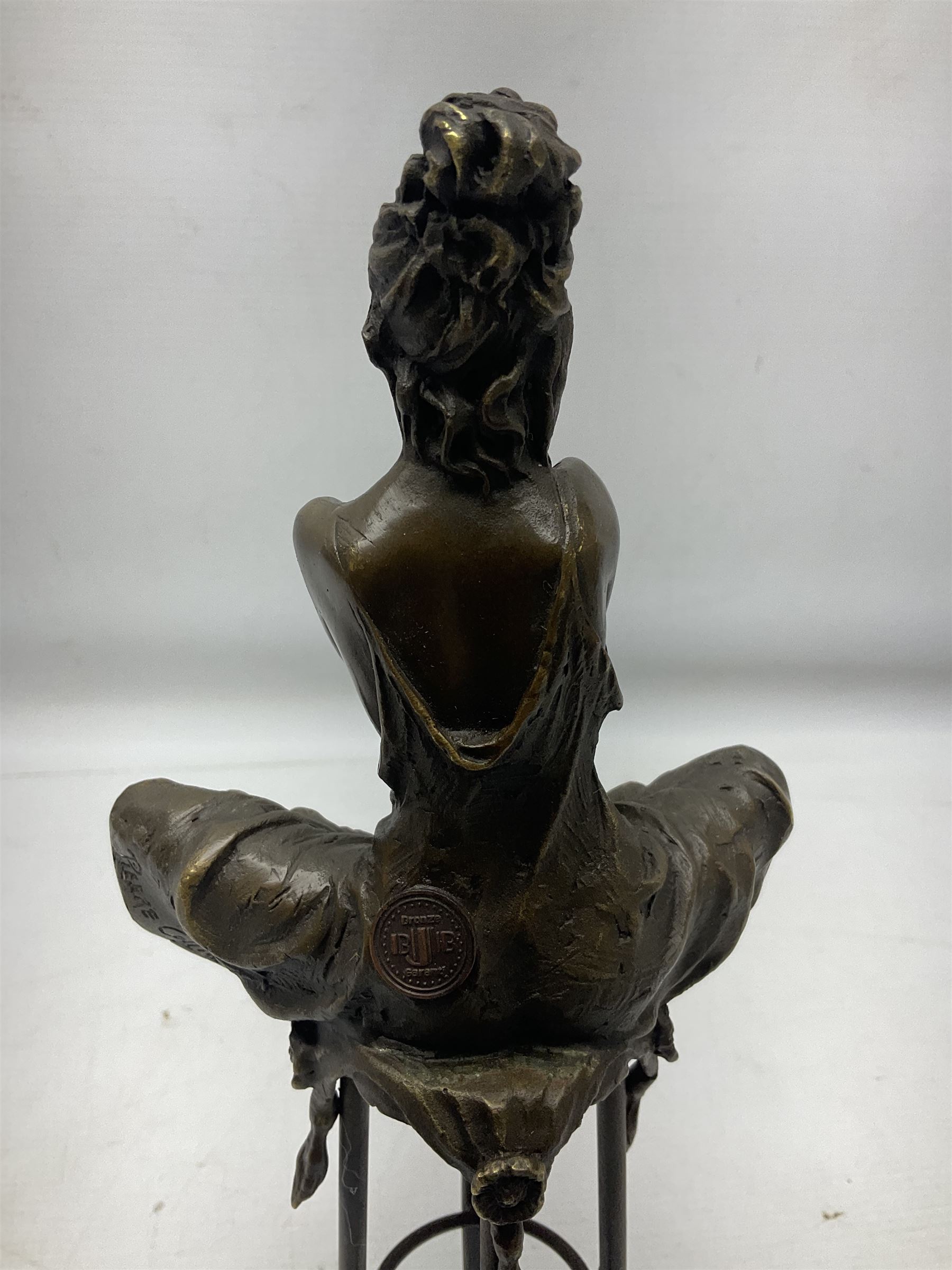 Art Deco style bronze modelled as a female figure seating crossed legged upon a chair, after Pierre Collinet, H28cm