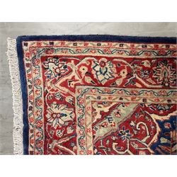 Persian Kashan rug, blue ground field decorated with interlacing foliage and decorated with stylised flower heads, repeating guarded border with scrolling floral design
