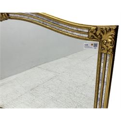 Deknudt - Regency design gilt framed wall mirror, arched shape with fleur-de-lis pediment, cushion frame