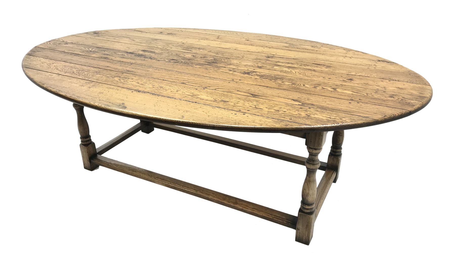 17th century style oval distressed light oak plank top dining table, rectangular stretcher base, L228cm, W150cm, H77cm