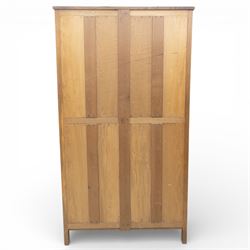 Acornman - oak adzed panelled double wardrobe, with wrought iron hinges and carved oak latch revealing a single clothes rail, with signature carved acorn to top right, by the workshop of Alan Grainger, Brandsby