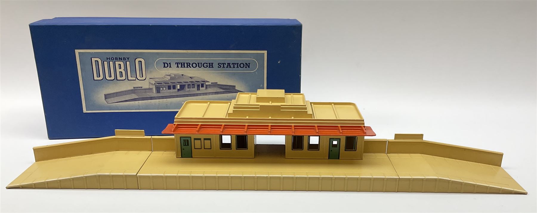 Hornby Dublo - six D1 accessories comprising Turntable; Through Station with white edges and separately boxed Platform Extension with Wall; Signal Cabin with orange roof and pack of station names; Level Crossing; and Island Platform; all boxed (6)