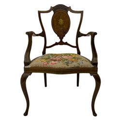Edwardian inlaid mahogany elbow chair, shell carved cresting rail over oval back splat with scrolling foliage and shell mask inlays, with needlework upholstered seat, on cabriole supports