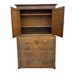 Georgian oak and mahogany banded cupboard on chest, projecting cornice over frieze and two panelled doors, the chest fitted with two short and three long drawers