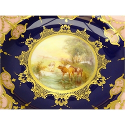  Early 20th century Royal Worcester compote hand painted with cattle drinking from a river by Harry Stinton within a raised gilt panelled border on cobalt blue ground, manufactured for H.C.S. Stephenson Ltd, 1913, H13cm x D24.5cm. Provenance Property of Bob Heath, Brandesburton Formerly of Ravenfield Hall Farm near Rotherham  
