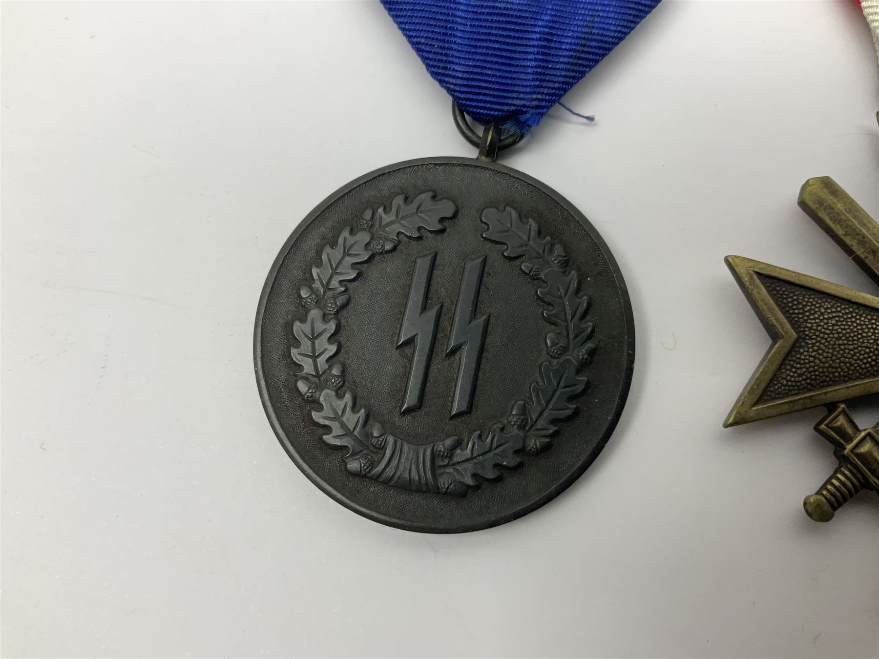 WWII German 'SS' Long Service Medal for four years; Ostfront Medal for the Winter Campaign in Russia of 1941-1942 'Die Medaille Winterschlacht Im Osten'; and War Merit Cross 2nd Class with swords; all with ribbons (3)