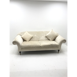 Three seat sofa upholstered in an cream chenille fabric, scrolled arms, turned supports, W220cm