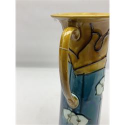 Minton secessionist vase, of tapering form with twin handles, decorated with white flowers on a blue and yellow ground, H29cm