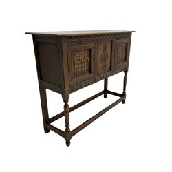 17th century style caved oak side cabinet, fitted with two cupboards, stretcher base