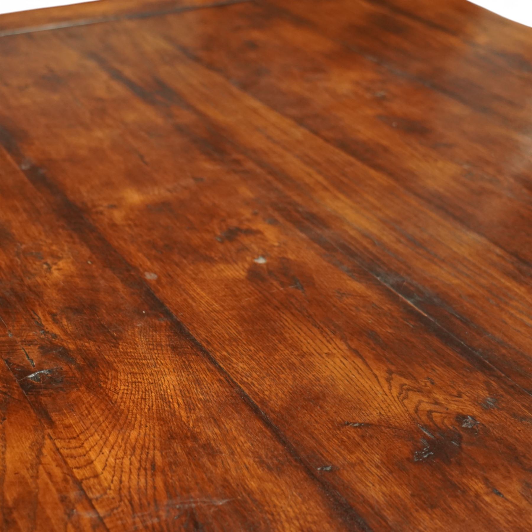 Country House 12' oak and fruitwood refectory dining table, the substantial rectangular plank top with cleated ends and chamfered edge, raised on twin trestle end square tapering and turned baluster supports with sledge feet and chamfered united by a long stretcher rail